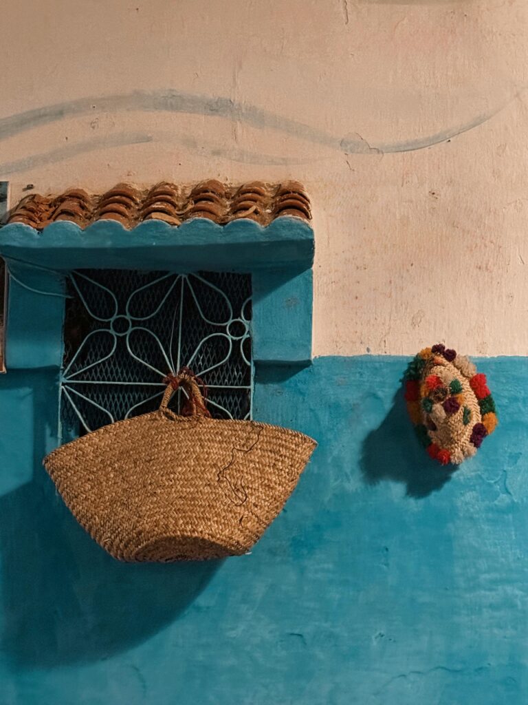Charming Moroccan wall with traditional basket and vibrant decor, showcasing regional style.