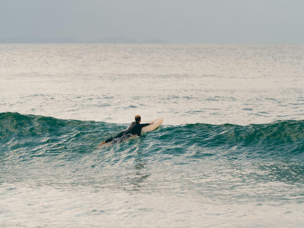 An adventurous surfer captures the thrill of surfing at Byron Bay, New South Wales, Australia.