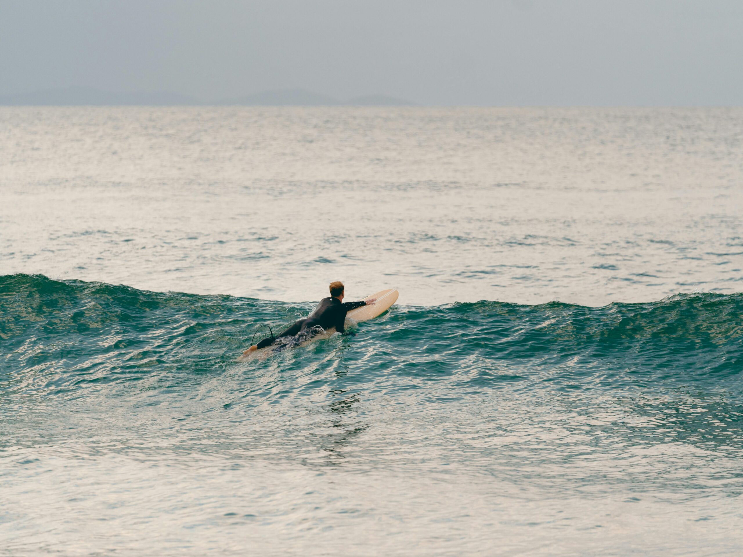An adventurous surfer captures the thrill of surfing at Byron Bay, New South Wales, Australia.